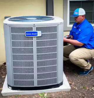  Brad Havins, owner of Lovejoy HVAC, working on an air conditioner