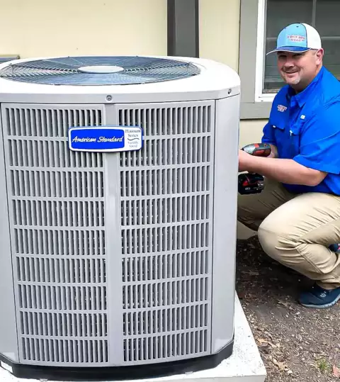 Brad Havins, owner of Lovejoy HVAC, works hard to install an AC unit in Allen TX